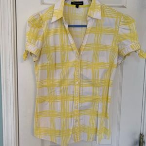 Yellow fitted button up shirt.